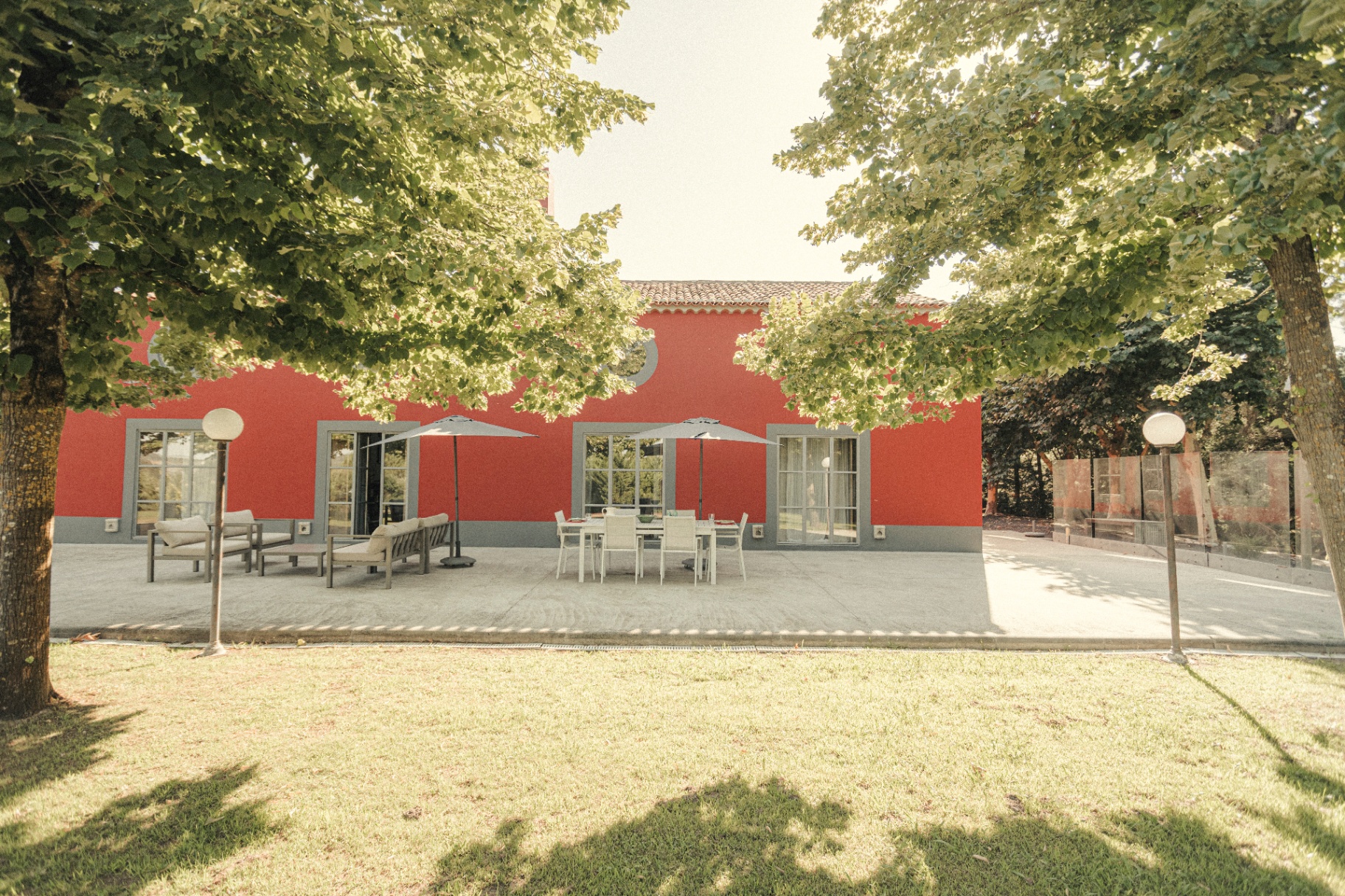 Red facade of the barn with terrace