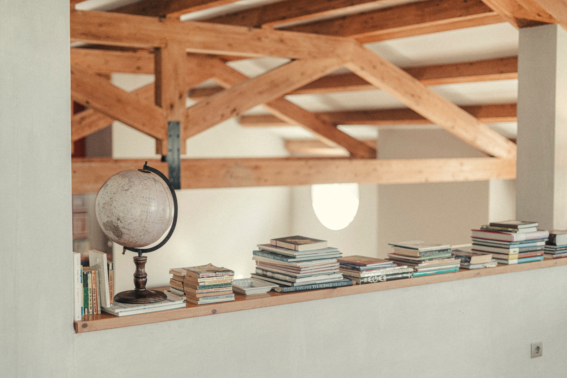 Library shelf beneath the timber roof trusses