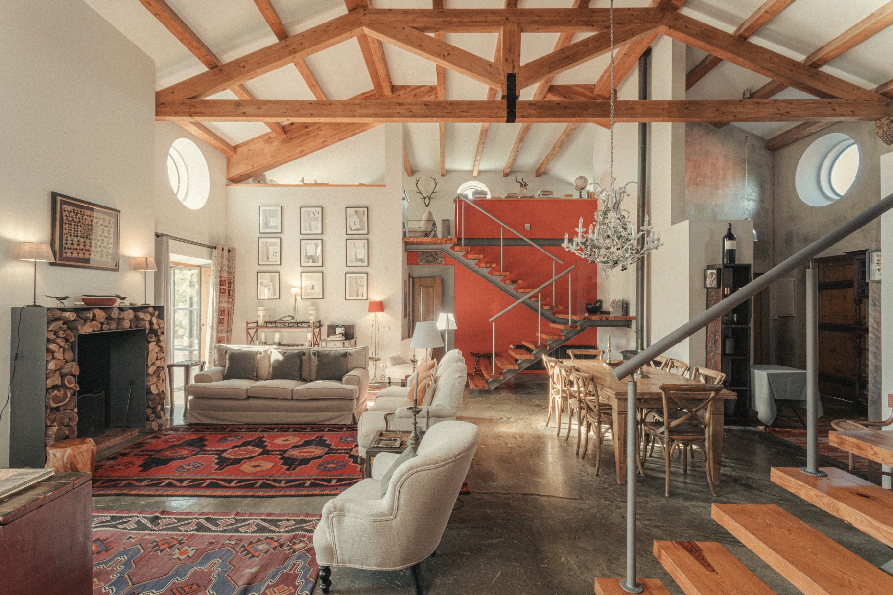 Living room with exposed beams and red staircase